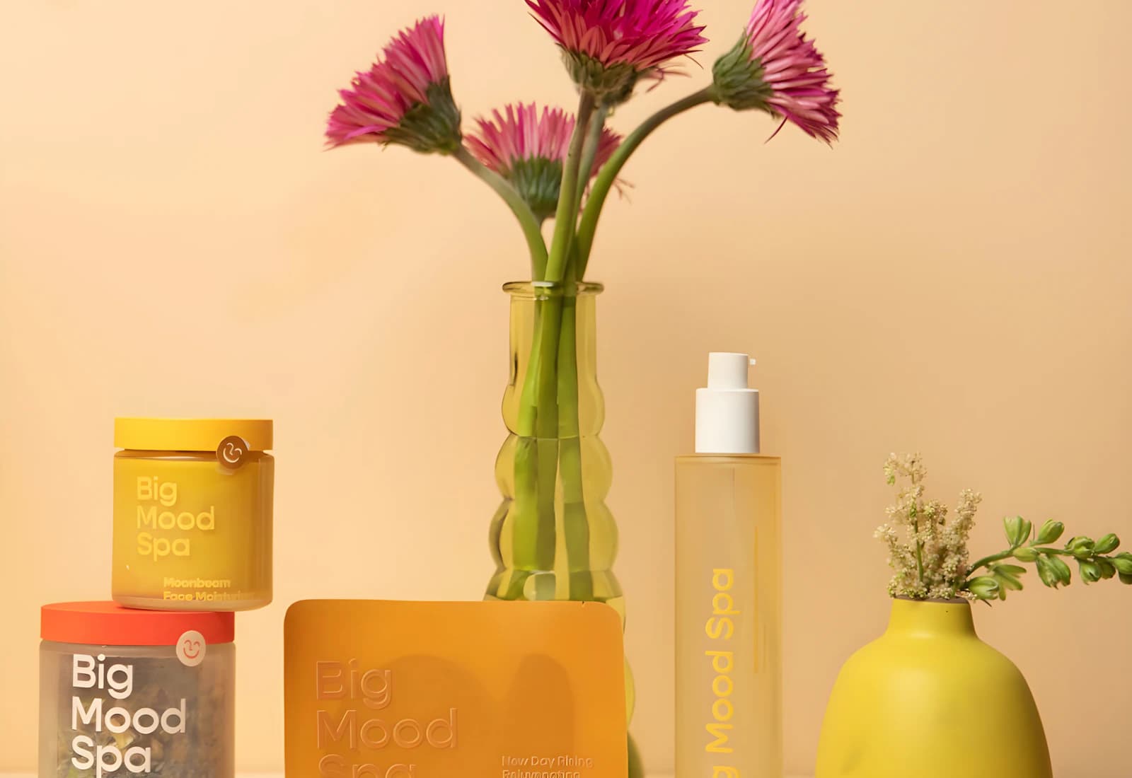 Spa-inspired skincare products arranged with vivid flowers